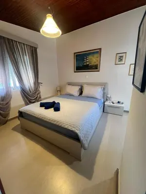 a bedroom with a bed with a blue towel on it at Nelly's Private Resindence in Chania Town