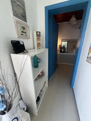 a hallway with a white cabinet and a blue door at Nelly's Private Resindence in Chania Town