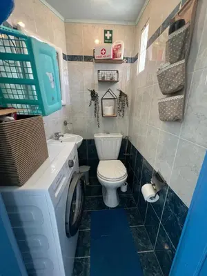 a bathroom with a toilet and a washing machine at Nelly's Private Resindence in Chania Town