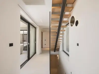 a staircase in a house with white walls at Villa Iocaste - With private pool and EV station in Chania Town