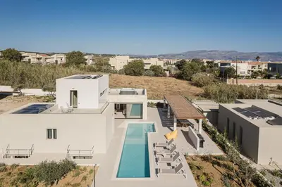 an aerial view of a white house with a swimming pool at Villa Iocaste - With private pool and EV station in Chania Town