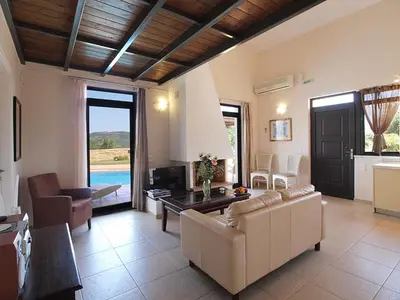 a living room with a couch and a table at Villa Bellissima in Chania Town