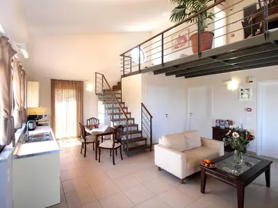 a kitchen and a living room with a couch and a table at Villa Bellissima in Chania Town