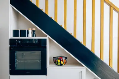 a kitchen with a staircase with a stove and a microwave at Anadia Luxury Pocket Villa Infinite Sea View in Falasarna