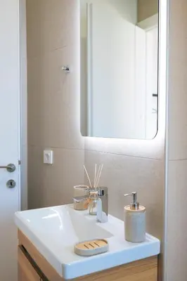 a bathroom with a white sink and a mirror at Anadia Luxury Pocket Villa Infinite Sea View in Falasarna