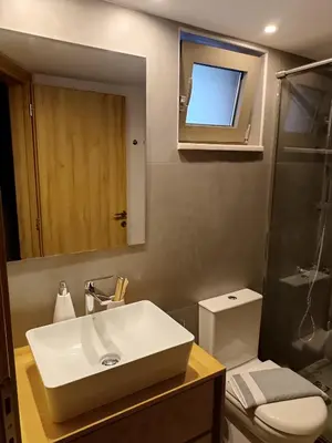 a bathroom with a sink and a toilet and a mirror at Boschini Loft Life in Chania Town