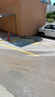 a white car parked in a parking lot next to a building at Boschini Loft Life in Chania Town