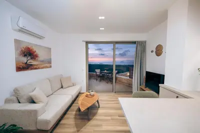 a living room with a couch and a table at Athali Luxury Pocket Villa Stunning Sea View in Falasarna