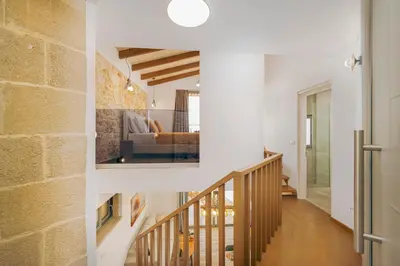 a staircase in a home with a brick wall at Athali Luxury Pocket Villa Stunning Sea View in Falasarna