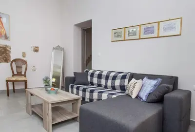 a living room with a couch and a table at Kalliston City House with a Yard in Chania Town