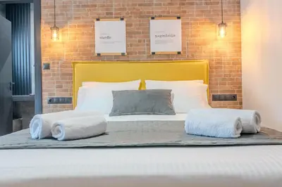 a large bed with two pillows on top of it at MOS Luxury Suits 