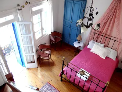 a bedroom with a bed with a pink blanket at Villa Archondisa in Chania Town