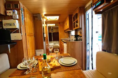a dining table with glasses and wine bottles on it at Lemon Garden Camper in Chania Town