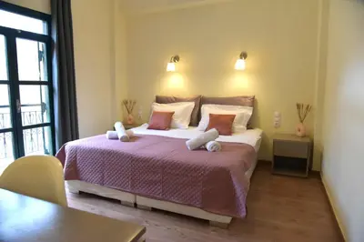 a bedroom with a bed with two stuffed animals on it at Madrugada in Chania Town