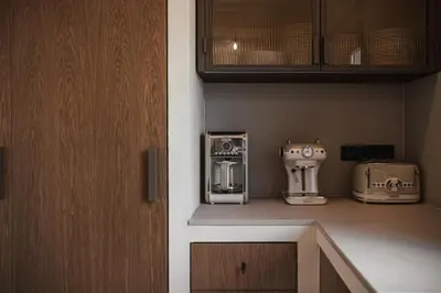a kitchen with appliances sitting on a shelf at Corte Interna, free heated pool in Kalivianí
