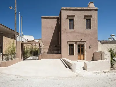 an old building with a door in front of it at Corte Interna, free heated pool in Kalivianí