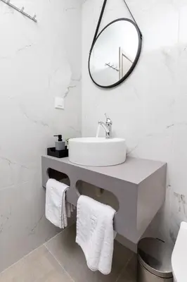 a bathroom with a sink and a mirror at Anele Luxury Suites - Roof Top Jacuzzi in Chania Town