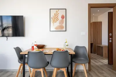 a dining room with a table and four chairs at Anele Luxury Suites - Roof Top Jacuzzi in Chania Town