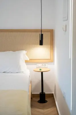 a bedroom with a bed and a small table at Studio Verde Glaros w. Outdoors, near the Beach in Kato Daratso