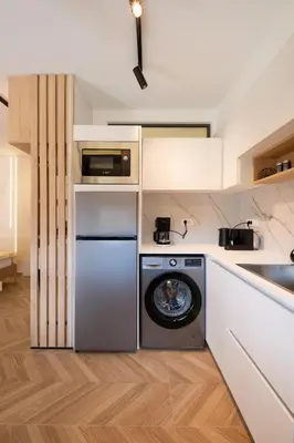 a kitchen with a washer and a dishwasher at Studio Verde Glaros w. Outdoors, near the Beach in Kato Daratso