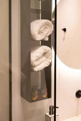 a towel rack in a bathroom with towels at Studio Verde Glaros w. Outdoors, near the Beach in Kato Daratso