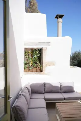 a living room with a couch and a window at Mystiko Maisonette with Hot Tub - Chania Old Town in Chania Town