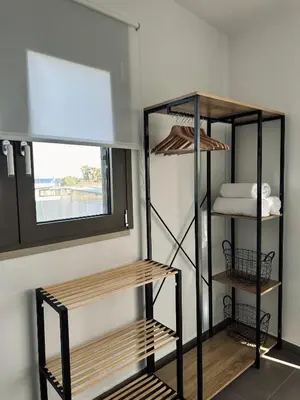 a room with three shelves in a room with a window at Serenity Living in Palaiochóra