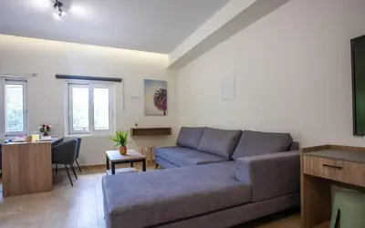 a living room with a couch and a table at AZOGIRE Resort in Azoyirés