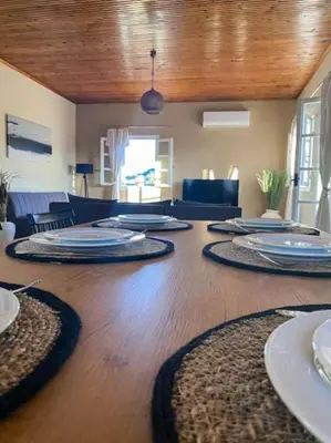 a large wooden table with plates on top of it at Olives Villa in Anopoli Sfakion