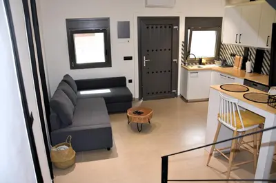 a small living room with a couch and a table at Gkerola house - small cozy house close to Chania town center in Chania Town