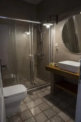 a bathroom with a shower and a toilet and a sink at Elia Daliani in Chania Town