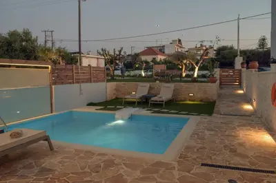 a swimming pool on the roof of a house at Sun Flower Villas in Agia Marina Nea Kydonias