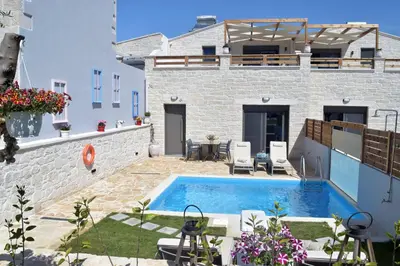 a villa with a swimming pool and a house at Sun Flower Villas in Agia Marina Nea Kydonias