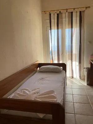 a small bed in a room with a window at Evgoro in Chania Town