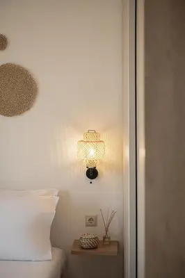 a bedroom with a bed and a lamp on the wall at Sol Luxury Apartment - close to the beach with a private heated mini pool in Chania Town