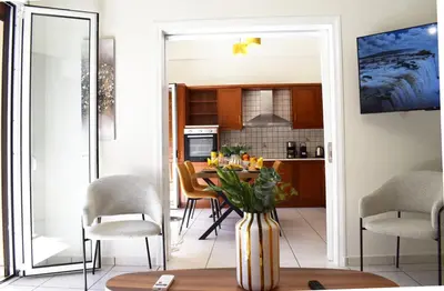 a kitchen and dining room with a table and chairs at NAMA -Central vacation rental with free parking only 900m far from Venetian Port and beach! in Chania Town