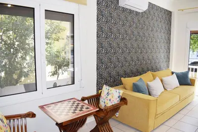 a living room with a couch and a table at NAMA -Central vacation rental with free parking only 900m far from Venetian Port and beach! in Chania Town