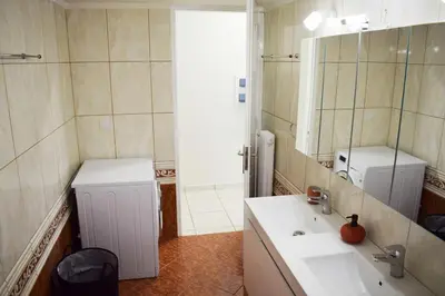 a bathroom with a sink and a mirror at NAMA -Central vacation rental with free parking only 900m far from Venetian Port and beach! in Chania Town