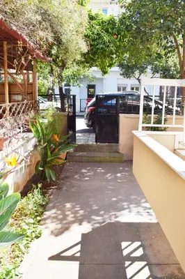 a driveway with a black gate in a yard at NAMA -Central vacation rental with free parking only 900m far from Venetian Port and beach! in Chania Town
