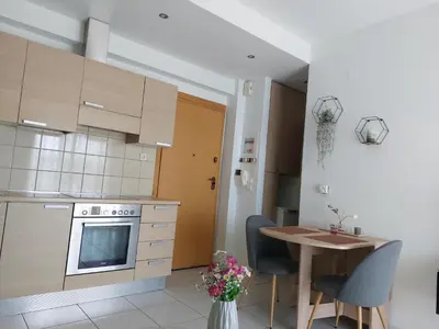 a kitchen with a table and a stove and a table at Eva's Suite in Chania Town