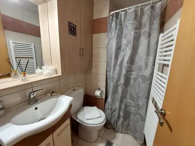 a bathroom with a sink and a toilet and a shower at Eva's Suite in Chania Town
