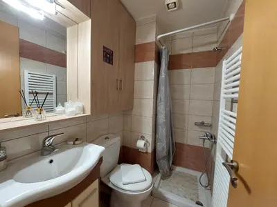a bathroom with a sink and a toilet and a shower at Eva's Suite in Chania Town
