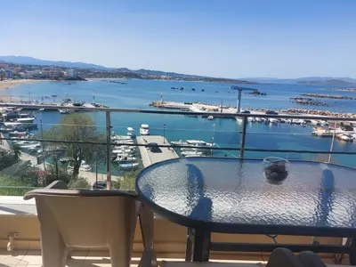 a table and chairs on a balcony with a view of a harbor at Eva's Suite in Chania Town