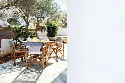 a table and chairs sitting on a patio at Delvia Luxury Residence in Agios Onoufrios