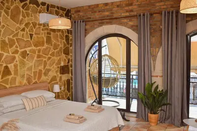 a bedroom with a bed and a stone wall at Κρητικό παραδοσιακό διαμέρισμα! in Chania Town