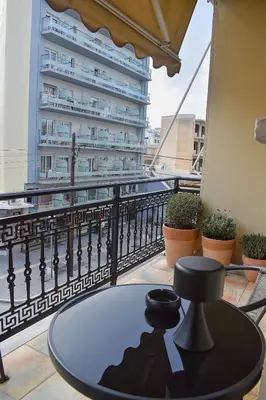 a table on a balcony with a building at Κρητικό παραδοσιακό διαμέρισμα! in Chania Town