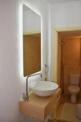 a bathroom with a white sink and a mirror at Κρητικό παραδοσιακό διαμέρισμα! in Chania Town
