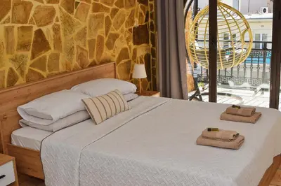 a bedroom with a bed with towels on it at Κρητικό παραδοσιακό διαμέρισμα! in Chania Town