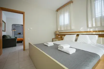 a bedroom with a large bed with towels on it at Zoe's Place - 1 BD Beachfront Apartment in Kissamos