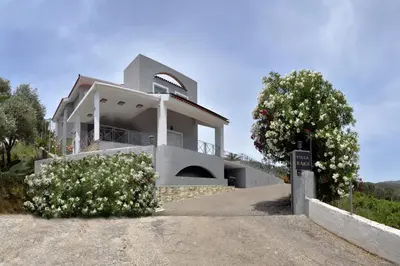 a house with white flowers in front of it at Villa Raks in Kántanos